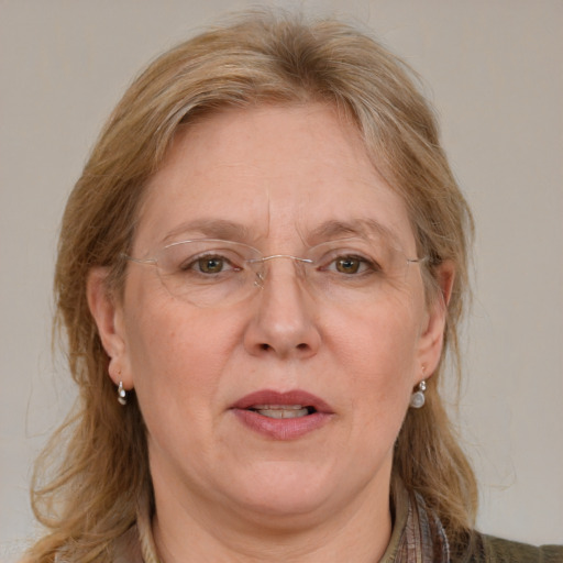 Joyful white adult female with medium  brown hair and blue eyes