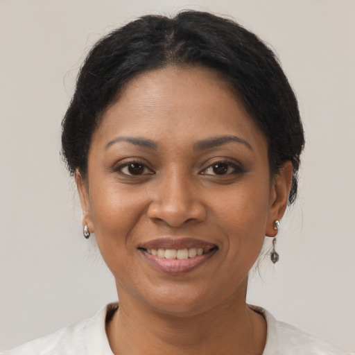 Joyful latino adult female with short  brown hair and brown eyes
