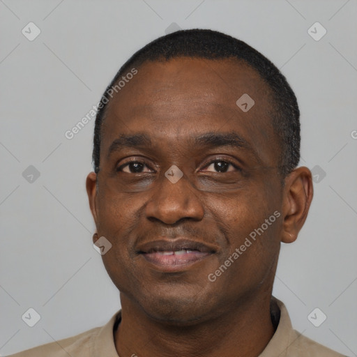 Joyful black adult male with short  black hair and brown eyes