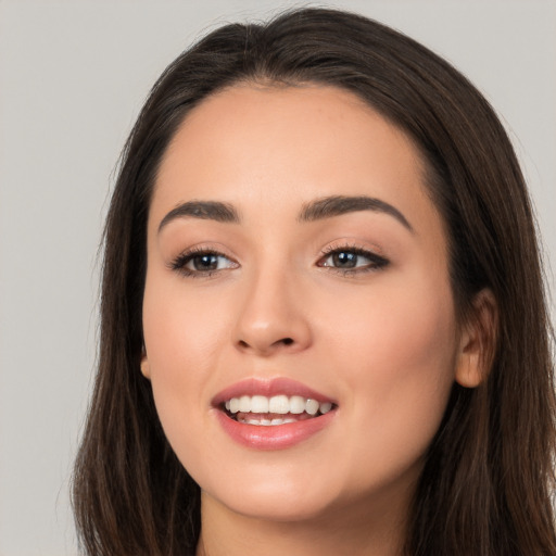 Joyful white young-adult female with long  brown hair and brown eyes