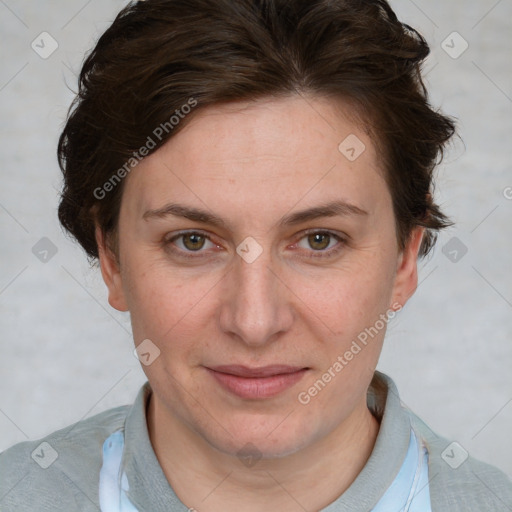 Joyful white adult female with short  brown hair and blue eyes