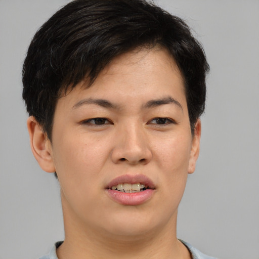 Joyful asian young-adult female with short  brown hair and brown eyes