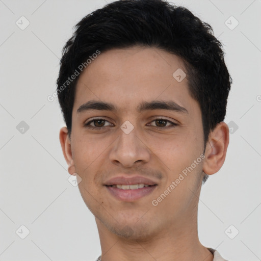 Joyful latino young-adult male with short  black hair and brown eyes