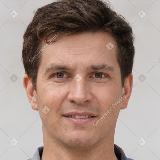 Joyful white adult male with short  brown hair and brown eyes