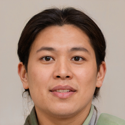 Joyful asian young-adult female with short  brown hair and brown eyes