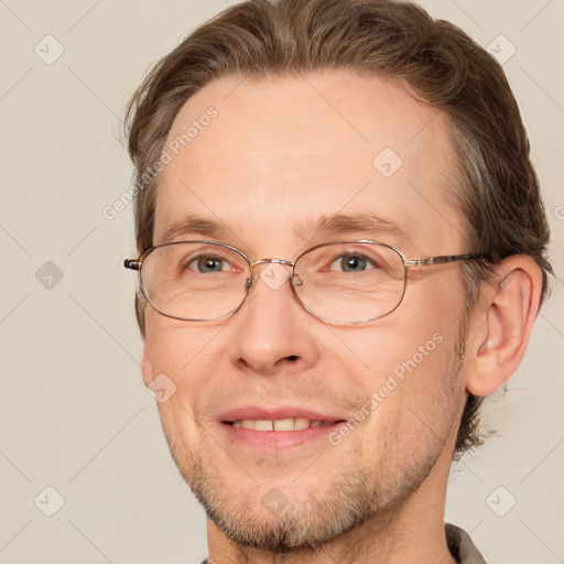 Joyful white adult male with short  brown hair and brown eyes