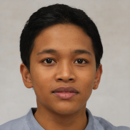 Joyful asian child male with short  black hair and brown eyes
