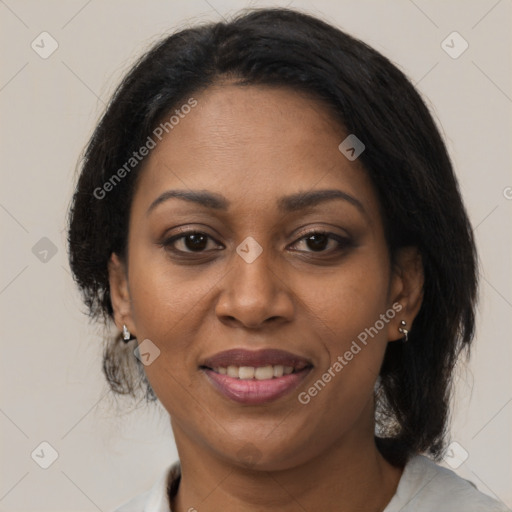 Joyful black adult female with medium  brown hair and brown eyes