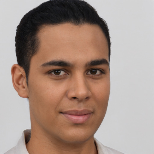 Joyful latino young-adult male with short  brown hair and brown eyes