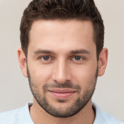 Joyful white young-adult male with short  brown hair and brown eyes