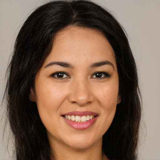 Joyful latino young-adult female with long  brown hair and brown eyes