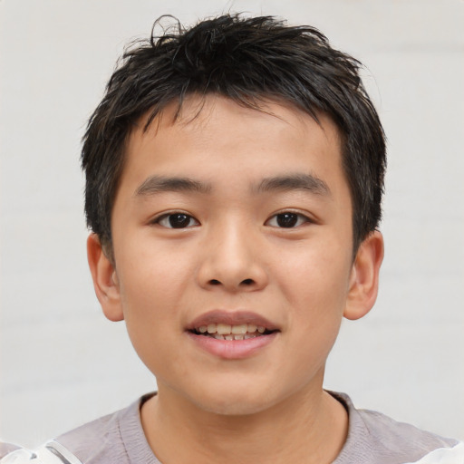 Joyful asian child male with short  brown hair and brown eyes