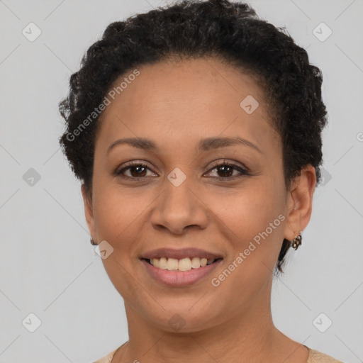 Joyful black adult female with short  brown hair and brown eyes