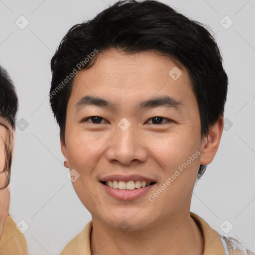 Joyful asian young-adult male with short  brown hair and brown eyes