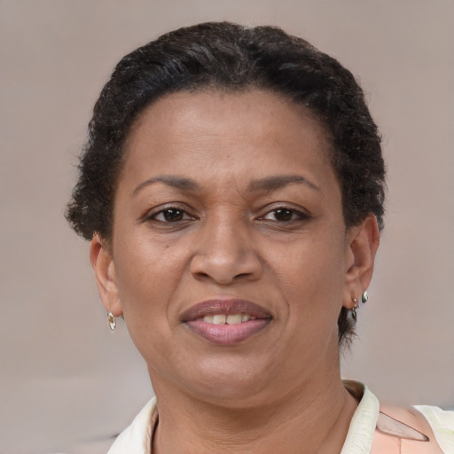 Joyful latino adult female with short  brown hair and brown eyes