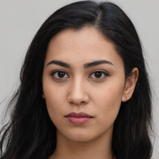 Neutral latino young-adult female with long  brown hair and brown eyes