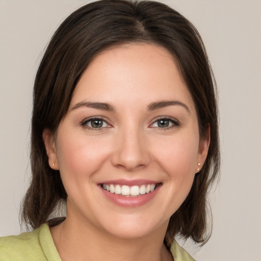 Joyful white young-adult female with medium  brown hair and brown eyes