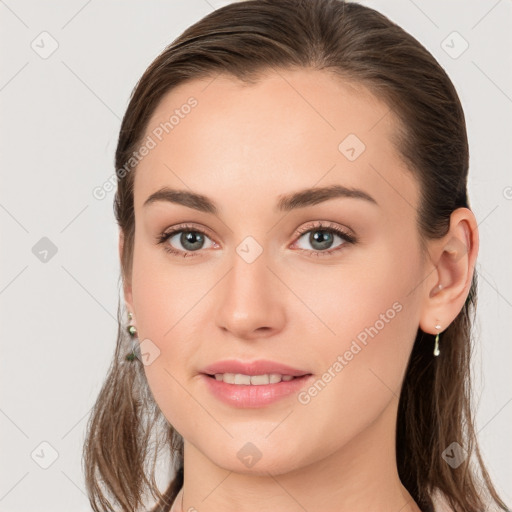 Joyful white young-adult female with long  brown hair and grey eyes