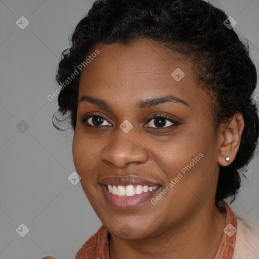 Joyful black young-adult female with long  brown hair and brown eyes