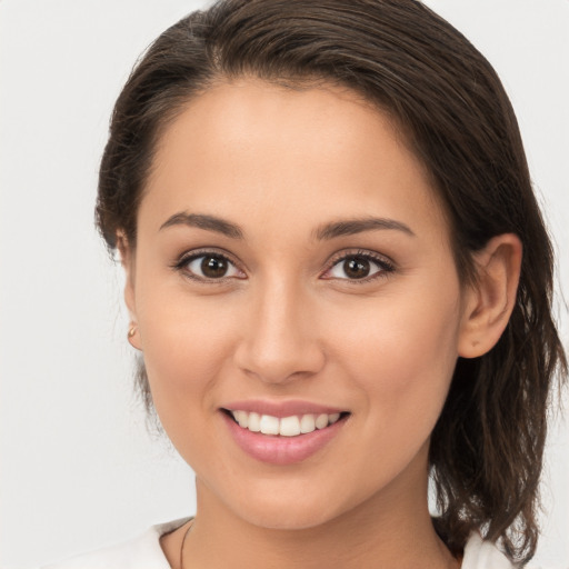 Joyful white young-adult female with medium  brown hair and brown eyes