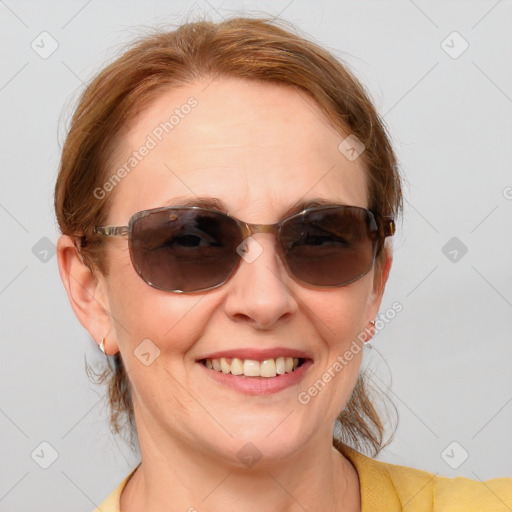 Joyful white young-adult female with medium  brown hair and blue eyes