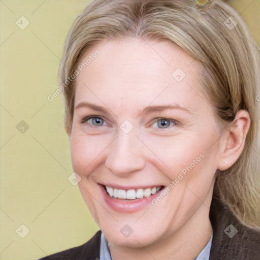 Joyful white adult female with medium  brown hair and blue eyes