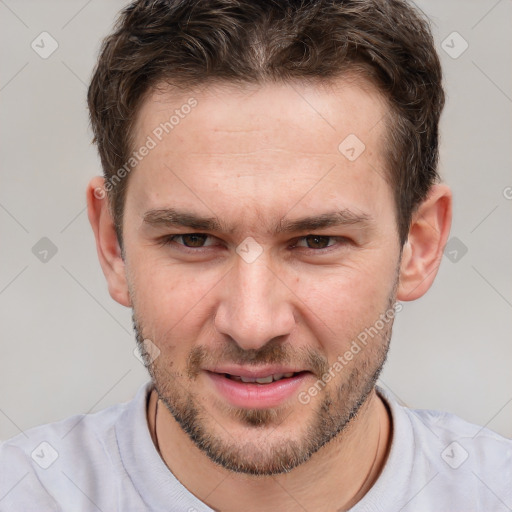 Joyful white adult male with short  brown hair and brown eyes