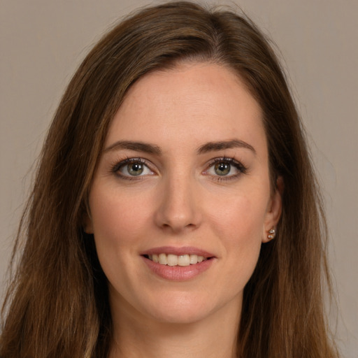 Joyful white young-adult female with long  brown hair and green eyes