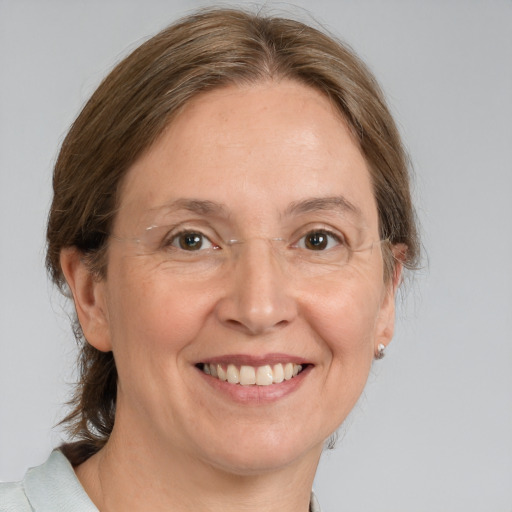 Joyful white adult female with medium  brown hair and grey eyes