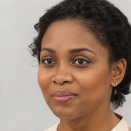 Joyful black young-adult female with medium  brown hair and brown eyes