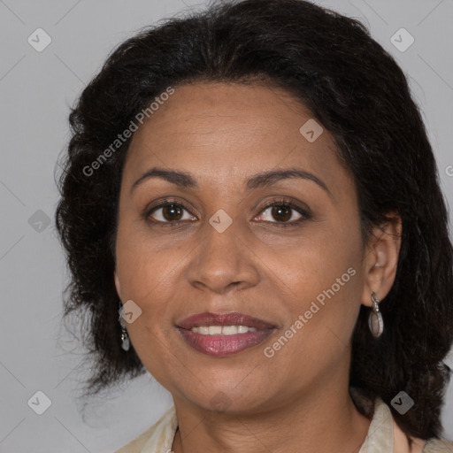 Joyful latino adult female with medium  brown hair and brown eyes