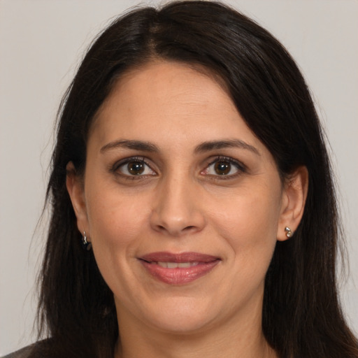 Joyful white adult female with long  brown hair and brown eyes