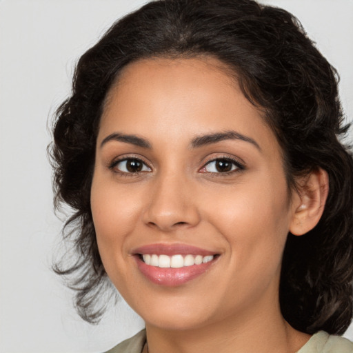 Joyful latino young-adult female with medium  brown hair and brown eyes