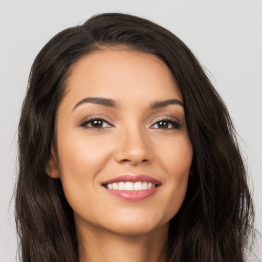 Joyful latino young-adult female with long  brown hair and brown eyes