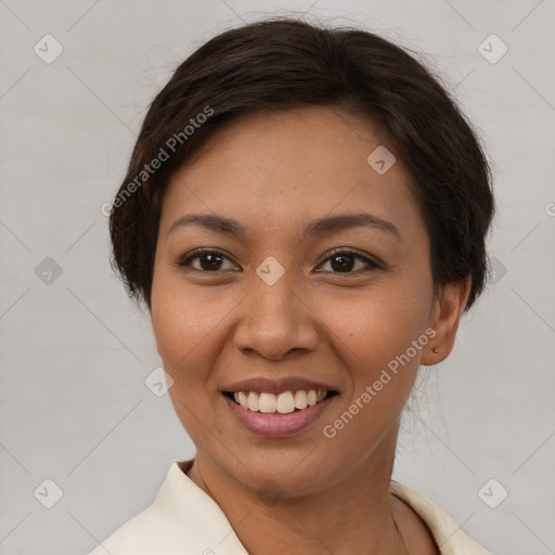 Joyful latino young-adult female with short  brown hair and brown eyes