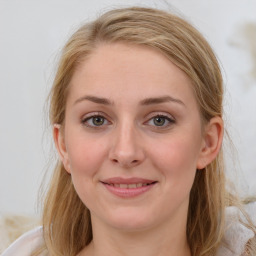 Joyful white young-adult female with medium  brown hair and blue eyes