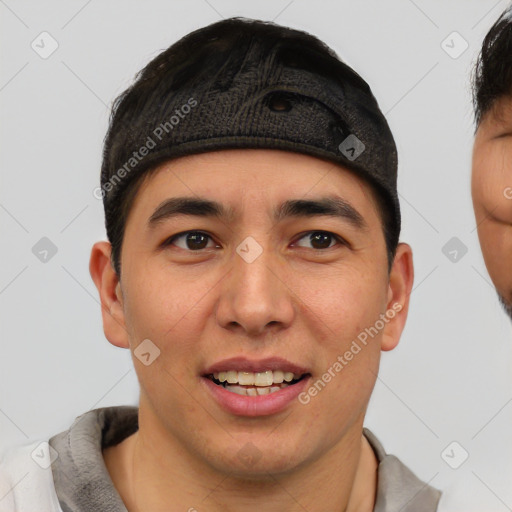 Joyful asian young-adult male with short  black hair and brown eyes