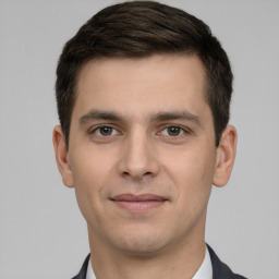 Joyful white young-adult male with short  brown hair and brown eyes