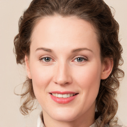 Joyful white young-adult female with medium  brown hair and green eyes