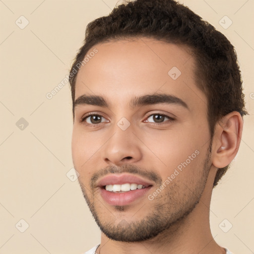 Joyful white young-adult male with short  black hair and brown eyes