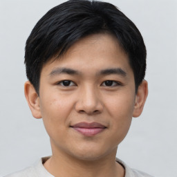 Joyful asian young-adult male with short  black hair and brown eyes