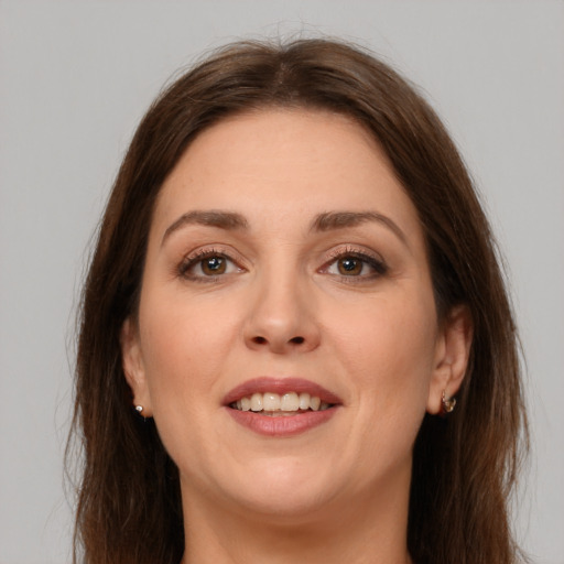 Joyful white young-adult female with long  brown hair and brown eyes