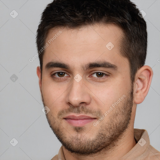 Joyful white young-adult male with short  brown hair and brown eyes