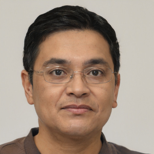 Joyful asian adult male with short  black hair and brown eyes