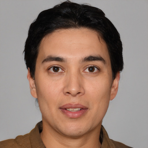 Joyful white young-adult male with short  black hair and brown eyes