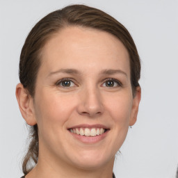 Joyful white adult female with short  brown hair and grey eyes