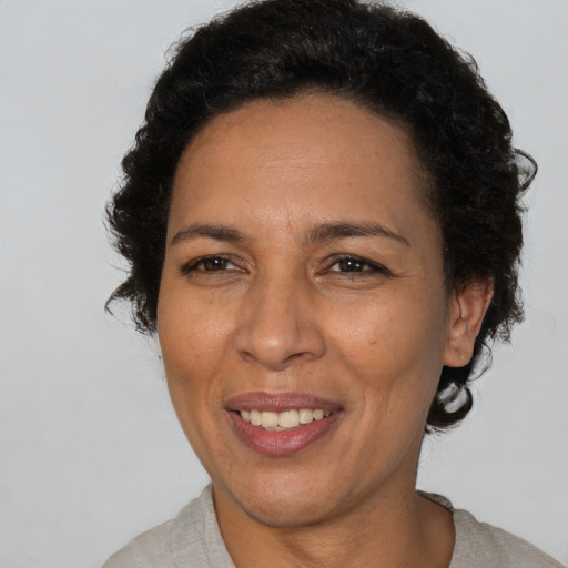 Joyful latino adult female with short  brown hair and brown eyes