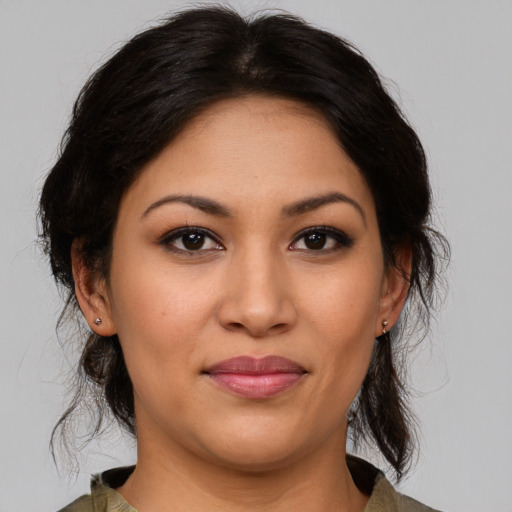 Joyful latino young-adult female with medium  brown hair and brown eyes