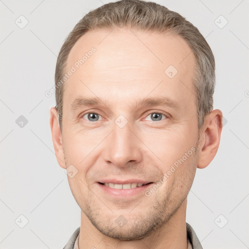 Joyful white adult male with short  brown hair and grey eyes