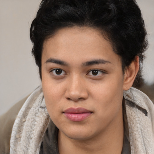 Joyful latino young-adult female with short  brown hair and brown eyes